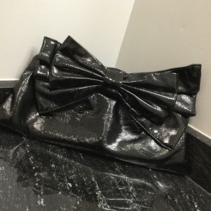 Black clutch purse with bow.